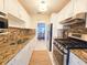 Modern kitchen with granite countertops, stainless steel appliances, and ample cabinet space, perfect for cooking at 5935 30Th S Ave # 308, Gulfport, FL 33707