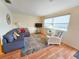 Inviting living room with a comfortable couch, bright rug, and large windows that fill the space with natural light at 5935 30Th S Ave # 308, Gulfport, FL 33707