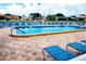 Beautiful community pool and lounge area with ample seating and lush landscaping at 5935 30Th S Ave # 308, Gulfport, FL 33707