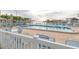 Relaxing outdoor pool area with lounge chairs and umbrellas overlooking the water at 5935 30Th S Ave # 308, Gulfport, FL 33707