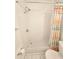 Shower features a tiled shower with sleek fixtures and a colorful shower curtain at 5935 30Th S Ave # 308, Gulfport, FL 33707