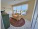 Cozy sunroom with a colorful braided rug and views of the boat docks and channel at 5935 30Th S Ave # 308, Gulfport, FL 33707