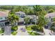 Stunning aerial view of the landscaped property with a paver driveway and tropical foliage at 597 Bay St, Palm Harbor, FL 34683