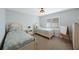A simply decorated bedroom with two beds, neutral walls, and a window with shuttered blinds at 597 Bay St, Palm Harbor, FL 34683