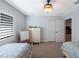 Neutral ' bedroom with two twin beds, closet and ceiling fan at 597 Bay St, Palm Harbor, FL 34683