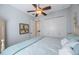 Comfortable bedroom with a ceiling fan and blue accents and large closet at 597 Bay St, Palm Harbor, FL 34683