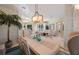 Elegant dining area with contemporary furnishings, an ornate light fixture, and views of the surrounding spaces at 597 Bay St, Palm Harbor, FL 34683