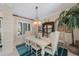 Dining room with a stylish light fixture, neutral walls, and views to the exterior at 597 Bay St, Palm Harbor, FL 34683