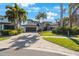 Beautifully landscaped home boasts a paver driveway and a two-car garage at 597 Bay St, Palm Harbor, FL 34683