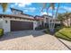 Stunning two-story home with a 2-car garage and a beautifully paved driveway lined with lush tropical landscaping at 597 Bay St, Palm Harbor, FL 34683