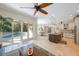 Open-concept kitchen with island, stainless appliances, and pool view at 597 Bay St, Palm Harbor, FL 34683