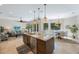Spacious kitchen with island, stainless steel appliances, and adjacent living area at 597 Bay St, Palm Harbor, FL 34683
