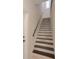 Well-lit stairway with wood and stone accents at 597 Bay St, Palm Harbor, FL 34683