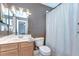 Bathroom featuring a vanity with sink, toilet, and a shower with a curtain at 6112 Ibispark Dr, Lithia, FL 33547