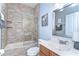 Bathroom featuring a tub/shower combo with tiled surround, glass doors, sink, and vanity at 6112 Ibispark Dr, Lithia, FL 33547