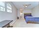 Bright bedroom featuring a bed, large arched window, and attached bath creating comfort at 6112 Ibispark Dr, Lithia, FL 33547