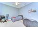 Bedroom with carpet, ceiling fan, desk, and cozy bean bag chair at 6112 Ibispark Dr, Lithia, FL 33547