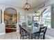 Bright dining area features a stylish table with seating, an adjacent living space and views of the screened lanai at 6112 Ibispark Dr, Lithia, FL 33547