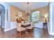 Elegant dining room with hardwood floors, chandelier, and large window for natural light at 6112 Ibispark Dr, Lithia, FL 33547