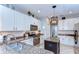 Well-lit kitchen boasts granite countertops, stainless steel appliances, and a center island with pendant lighting at 6112 Ibispark Dr, Lithia, FL 33547