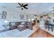 Spacious living room has an open floor plan, hardwood floors, leather furniture, and flows into the kitchen at 6112 Ibispark Dr, Lithia, FL 33547