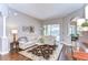 Bright living room featuring hardwood floors, modern decor, and access to the outdoor living area at 6112 Ibispark Dr, Lithia, FL 33547