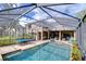 Resort style swimming pool with large patio featuring outdoor dining and grilling spaces at 6112 Ibispark Dr, Lithia, FL 33547