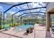 Screened pool with beautiful landscaping and outdoor furniture is great for entertaining at 6112 Ibispark Dr, Lithia, FL 33547