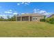 Spacious backyard with lush lawn and covered, screened in lanai at 626 15Th Nw Ave, Ruskin, FL 33570