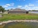 Scenic view of the back exterior and the lake behind the house at 626 15Th Nw Ave, Ruskin, FL 33570