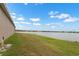 Backyard overlooking the lake and neighboring homes at 626 15Th Nw Ave, Ruskin, FL 33570