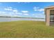 Expansive backyard featuring lush green lawn and tranquil lake views at 626 15Th Nw Ave, Ruskin, FL 33570