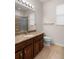 Well-lit bathroom featuring a granite vanity, a large mirror, and a walk-in shower for a spa-like experience at 626 15Th Nw Ave, Ruskin, FL 33570