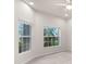 Bright bedroom with large windows, neutral walls, and a ceiling fan creating a calming and airy space at 626 15Th Nw Ave, Ruskin, FL 33570