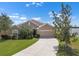 Charming single-story home featuring a well-manicured lawn, mature landscaping, and a two-car garage at 626 15Th Nw Ave, Ruskin, FL 33570