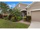 Charming one-story home with tropical landscaping, a welcoming entrance, and an attached two-car garage at 626 15Th Nw Ave, Ruskin, FL 33570