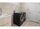 Laundry room featuring modern washer and dryer, utility sink and overhead storage at 626 15Th Nw Ave, Ruskin, FL 33570