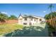 Backyard features a small lawn and green patio with an outdoor dining set at 630 48Th N Ave, St Petersburg, FL 33703