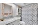 Charming bathroom features a vanity with a marble countertop and shell-adorned mirror at 630 48Th N Ave, St Petersburg, FL 33703