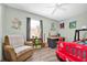 Bright bedroom featuring a cozy armchair, desk, and a car-shaped bed at 630 48Th N Ave, St Petersburg, FL 33703