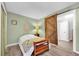 Cozy bedroom featuring a twin bed, wood sliding door, and neutral walls at 630 48Th N Ave, St Petersburg, FL 33703