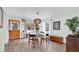 Inviting dining area with wood floors, light green walls, and unique globe chandelier at 630 48Th N Ave, St Petersburg, FL 33703