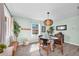 Cozy dining area filled with light from a window, decorative lighting, and calming wall color at 630 48Th N Ave, St Petersburg, FL 33703