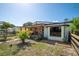 View of the charming home featuring stone accents, a covered porch and well maintained lawn at 630 48Th N Ave, St Petersburg, FL 33703