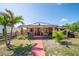 Charming home with unique stonework and a cozy porch, enhanced by vibrant greenery and palm trees at 630 48Th N Ave, St Petersburg, FL 33703
