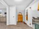 Well-lit hallway featuring wood floors, a dresser, and a doorway to another room at 630 48Th N Ave, St Petersburg, FL 33703