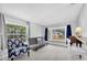 Cozy living area with bay window, stylish chair and carpet flooring at 630 48Th N Ave, St Petersburg, FL 33703