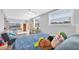 Relaxing living room features a cozy couch and a bed piled with pillows at 630 48Th N Ave, St Petersburg, FL 33703