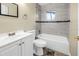 Bright bathroom with white vanity, matching toilet, and a shower-tub combo at 6515 Dimarco Rd, Tampa, FL 33634