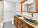 Elegant bathroom featuring double sinks, marble countertops, and a tiled shower at 6515 Dimarco Rd, Tampa, FL 33634